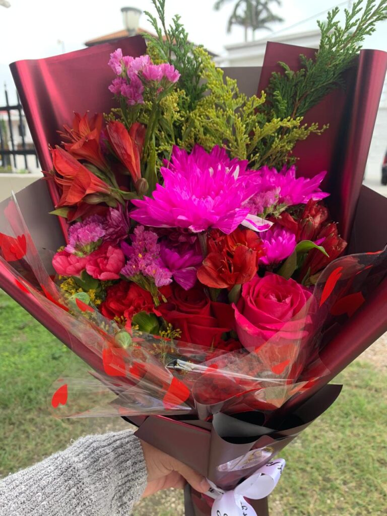 Bright sunflower floral arrangement with colorful flowers and greenery